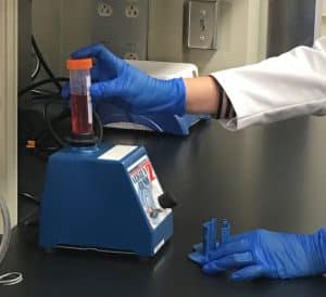Photo of Lab Technician testing a sample