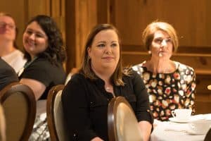 Woman listening to speakers at the awards presentation