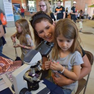 Young girl using a microscope
