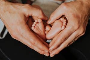 Hands around a baby's feet