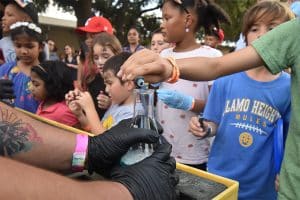 Children pouring liquids at Texas Biomed Family Night