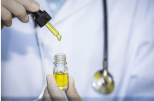 stock imagery of a person holding a dropper above a bottle