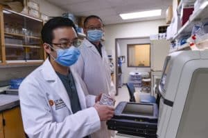 Kevin Chiem, Ph.D. candidate, and Chengjin Ye, Ph.D. in the lab